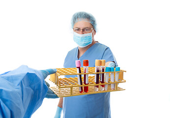 Image showing Pathologist hands blood tests to a laboratory worker