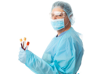 Image showing Doctor or nurse wearing full PPE and holding blood test tubes