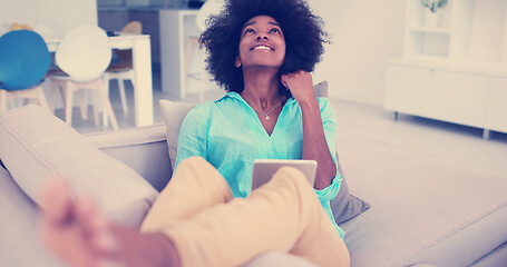 Image showing african american woman at home using digital tablet
