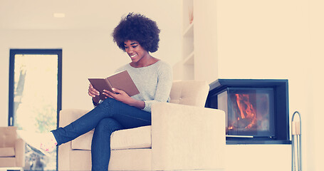 Image showing black woman at home reading book