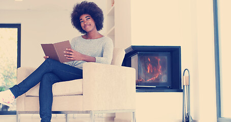 Image showing black woman at home reading book