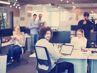 Image showing businessman working using a laptop in startup office