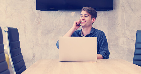 Image showing businessman working using a laptop in startup office