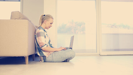 Image showing young women using laptop computer on the floor