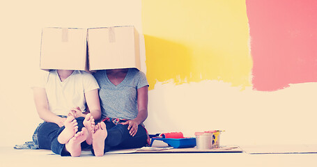 Image showing young multiethnic couple playing with cardboard boxes