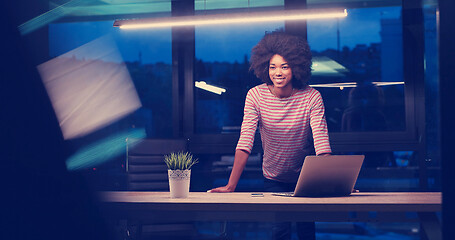 Image showing black businesswoman using a laptop in night startup office