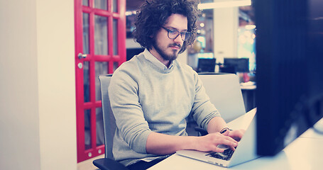 Image showing businessman working using a laptop in startup office