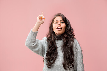 Image showing The happy business woman standing and smiling against pastel background.