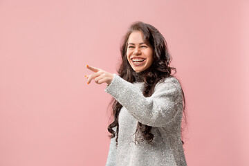 Image showing The happy business woman point you and want you, half length closeup portrait on pink background.