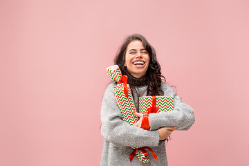 Image showing Woman with big beautiful smile holding colorful gift boxes.