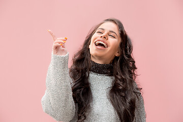 Image showing The happy business woman standing and smiling against pastel background.