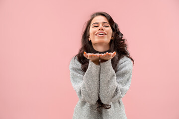 Image showing Portrait of attractive cute girl with bright makeup with kiss and love sign isolated over pink background