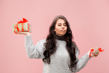 Image showing Woman with big beautiful smile holding colorful gift boxes.