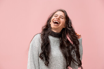 Image showing The happy business woman standing and smiling against pastel background.