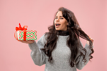 Image showing Woman with big beautiful smile holding colorful gift box.
