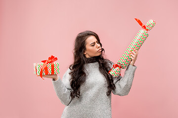 Image showing Woman with big beautiful smile holding colorful gift boxes.