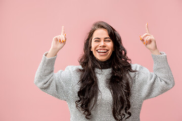 Image showing The happy business woman standing and smiling against pastel background.