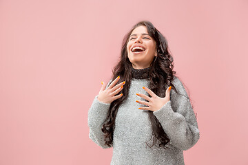 Image showing The happy business woman standing and smiling against pastel background.