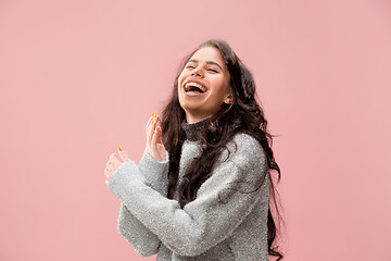 Image showing The happy business woman standing and smiling against pastel background.