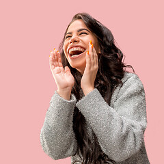 Image showing Isolated on pink young casual woman shouting at studio