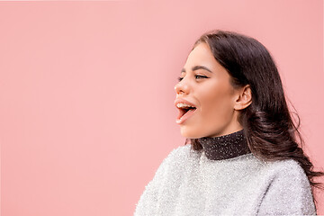 Image showing The happy business woman standing and smiling against pastel background.