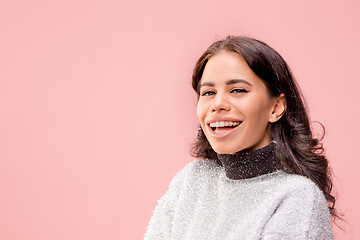 Image showing The happy business woman standing and smiling against pastel background.