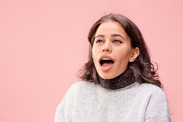 Image showing Beautiful woman looking suprised isolated on pink