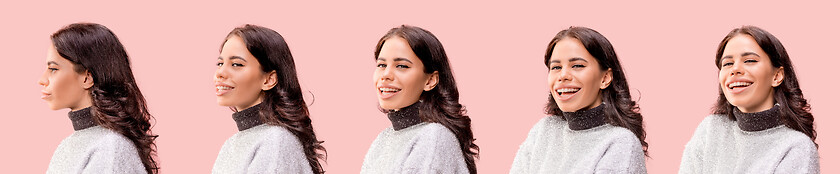 Image showing The happy business woman standing and smiling against pastel background.