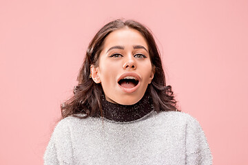 Image showing Beautiful woman looking suprised isolated on pink