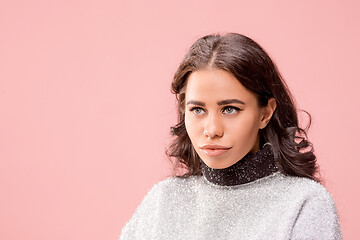 Image showing Serious business woman standing, looking at camera isolated on trendy pink studio background.