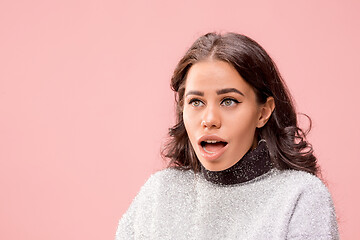 Image showing Beautiful woman looking suprised isolated on pink