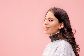 Image showing The happy business woman standing and smiling against pastel background.