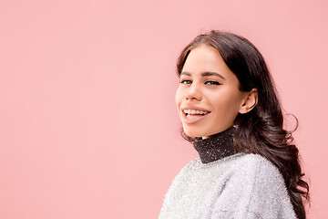 Image showing The happy business woman standing and smiling against pastel background.