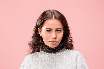 Image showing Serious business woman standing, looking at camera isolated on trendy pink studio background.