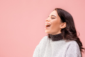 Image showing The happy business woman standing and smiling against pastel background.