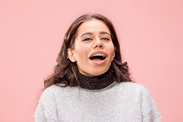 Image showing Beautiful woman looking suprised isolated on pink