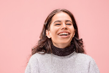 Image showing The happy business woman standing and smiling against pastel background.