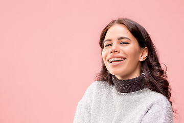 Image showing The happy business woman standing and smiling against pastel background.