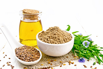 Image showing Flour linen in bowl with seeds and oil on light board