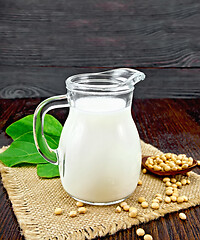 Image showing Milk soy in jug with beans on dark board