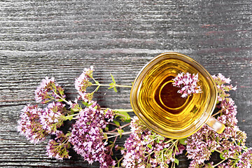 Image showing Tea of oregano in glass cup on board top