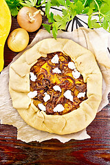 Image showing Pie with pumpkin and onions on wooden board top