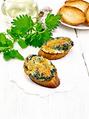 Image showing Sandwich of nettle and cheese on white board