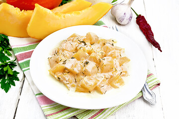 Image showing Pumpkin with sour cream sauce in plate on white board