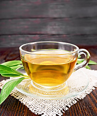 Image showing Tea herbal with sage in glass cup on wooden board