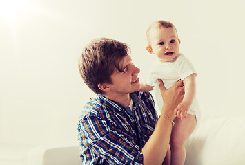 Image showing happy young father with little baby at home