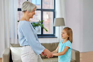 Image showing grandmother and granddaughter holding hands