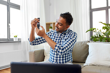 Image showing male blogger recording video review of smart watch
