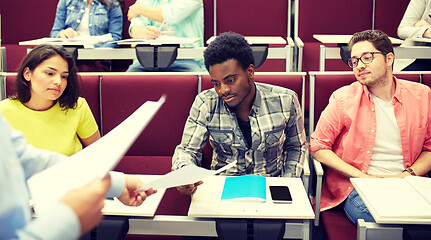 Image showing teacher giving tests to students at lecture