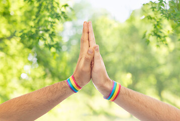 Image showing hands with gay pride wristbands make high five